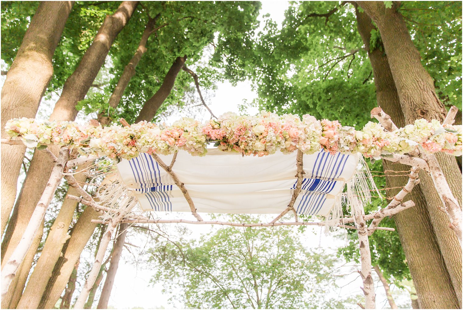 Floral chuppah with talis by Flowers by Joan