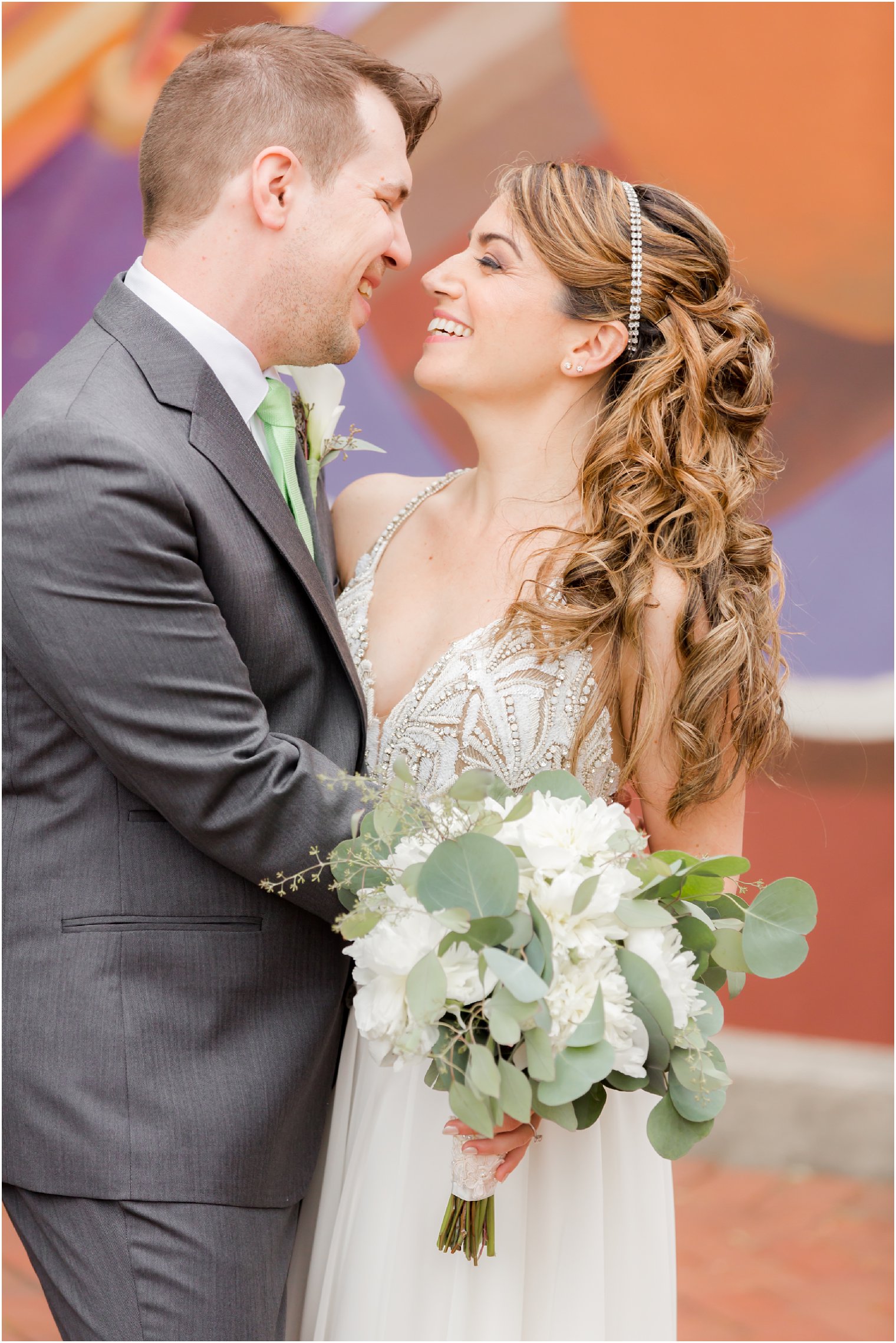 Bride and groom laughing on wedding day