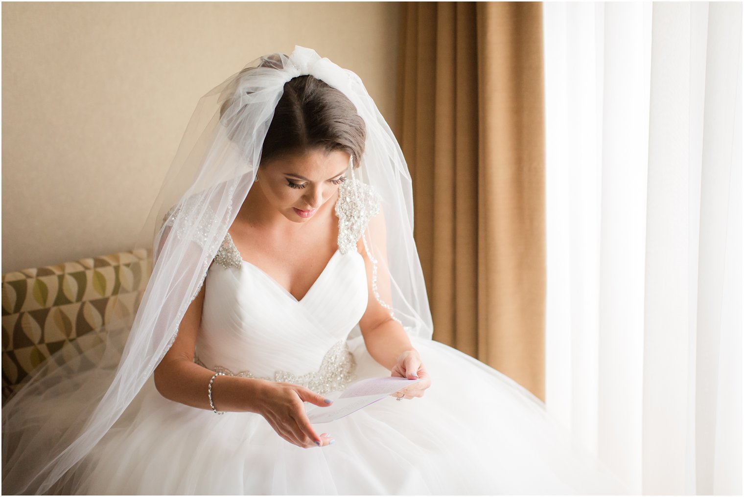 Bride reading letter from her groom at Windows on the Water at Frogbridge Wedding