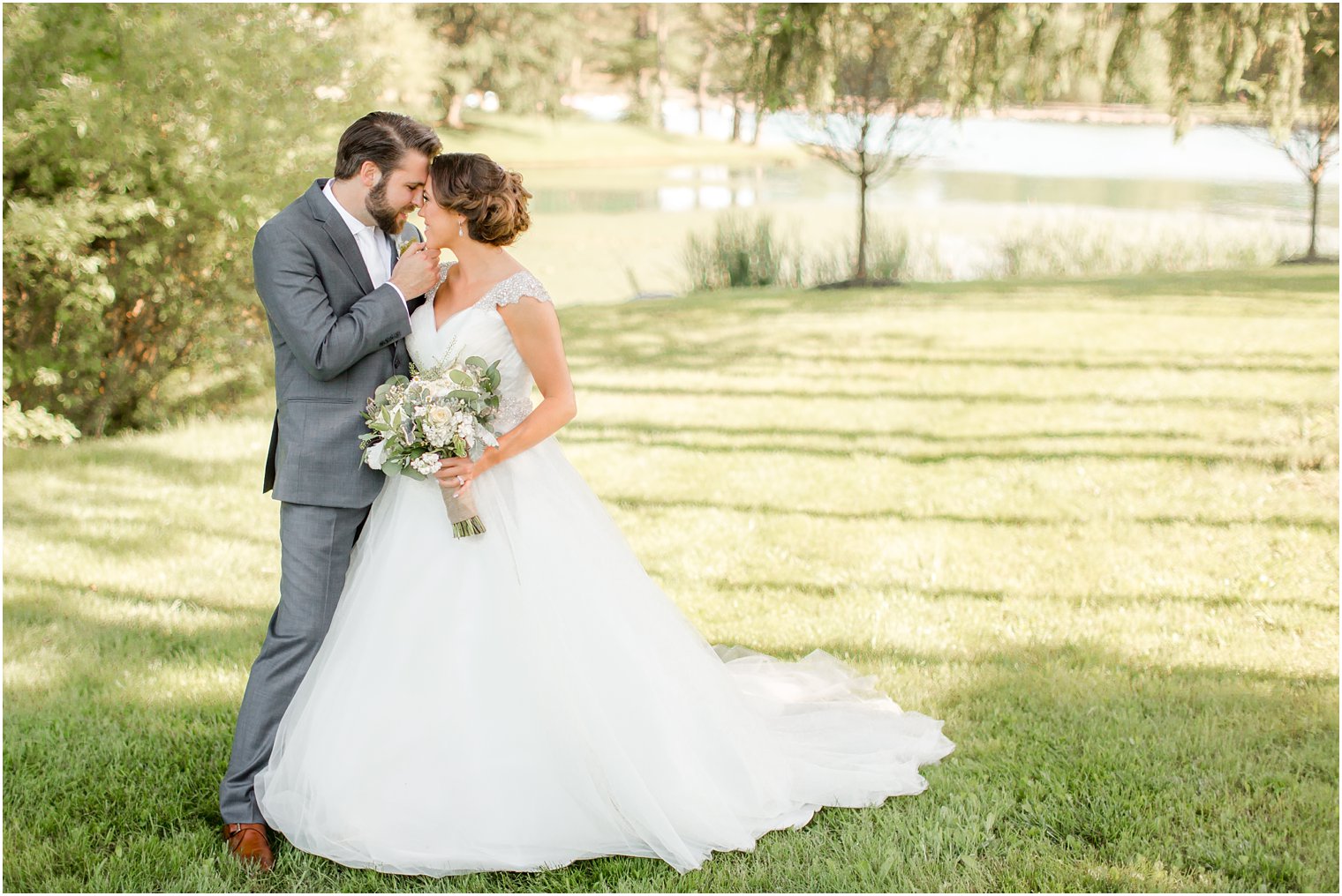 Sweet moment between bride and groom at Windows on the Water at Frogbridge Wedding