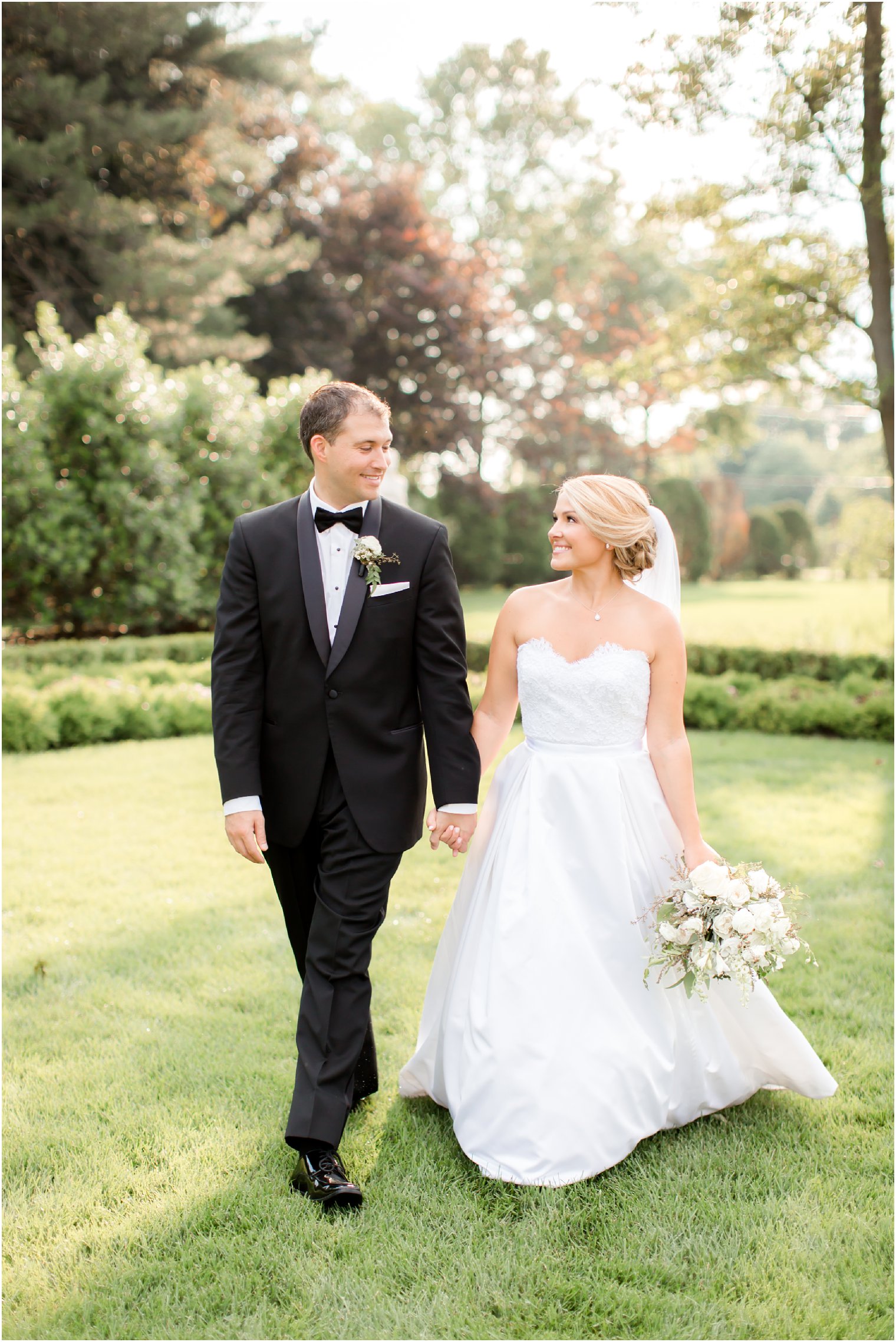 Bride and groom walking on grounds of Park Chateau Estate 