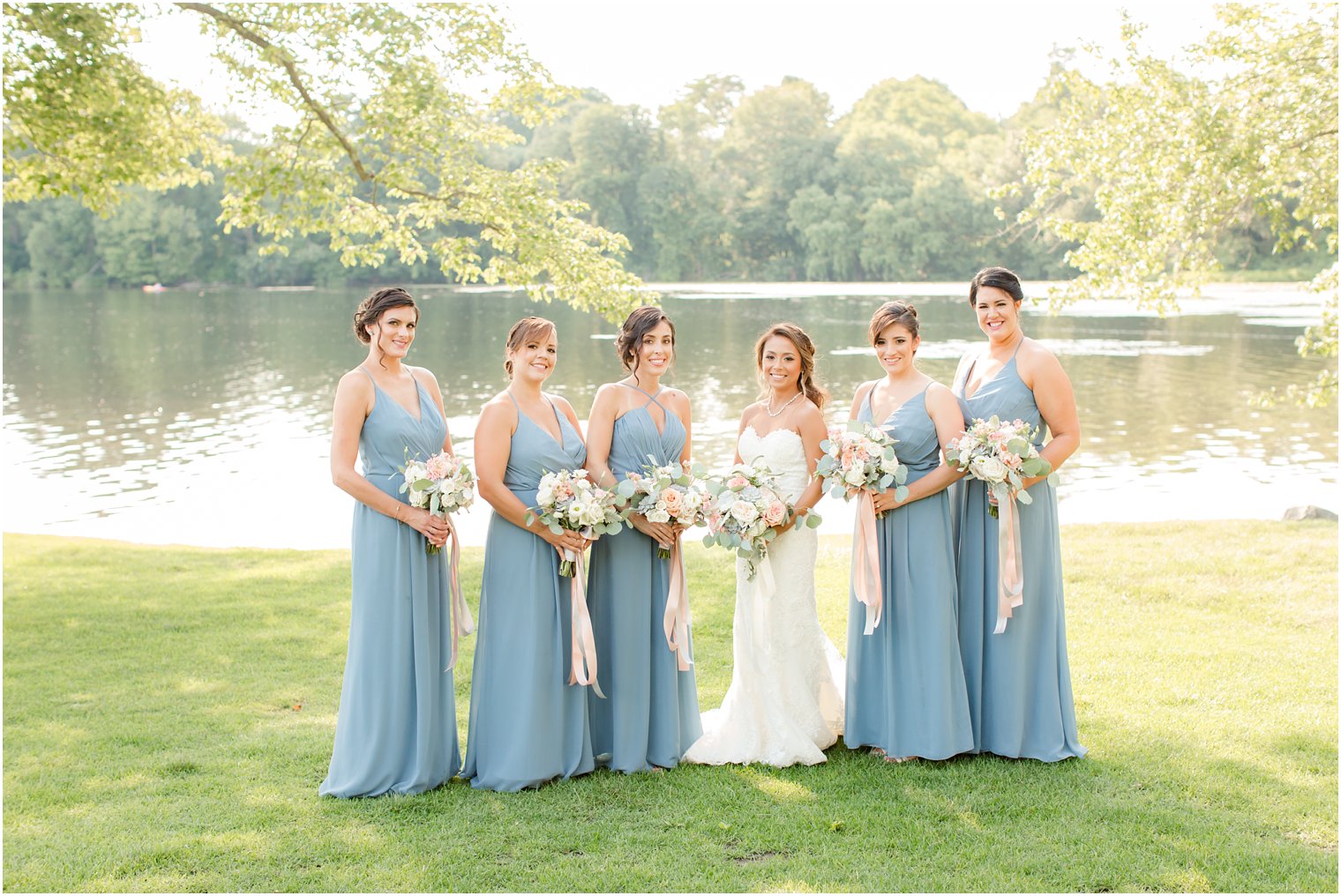 Brides holding bouquets with pink ribbon by Laurelwood Designs