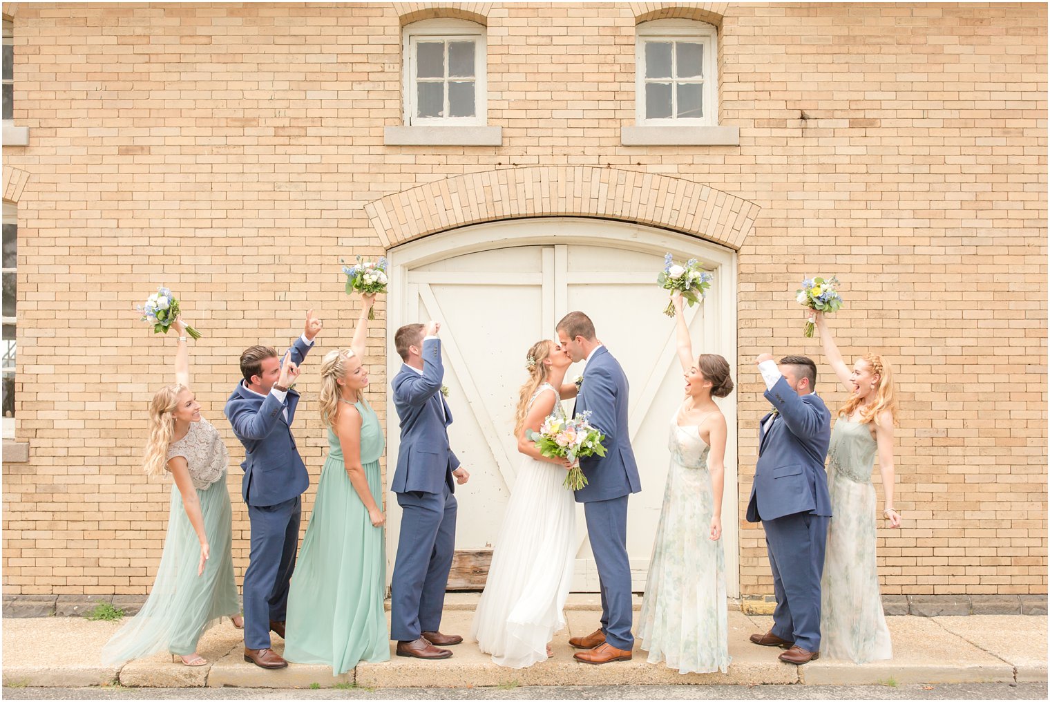 Bridal party cheering for newlyweds