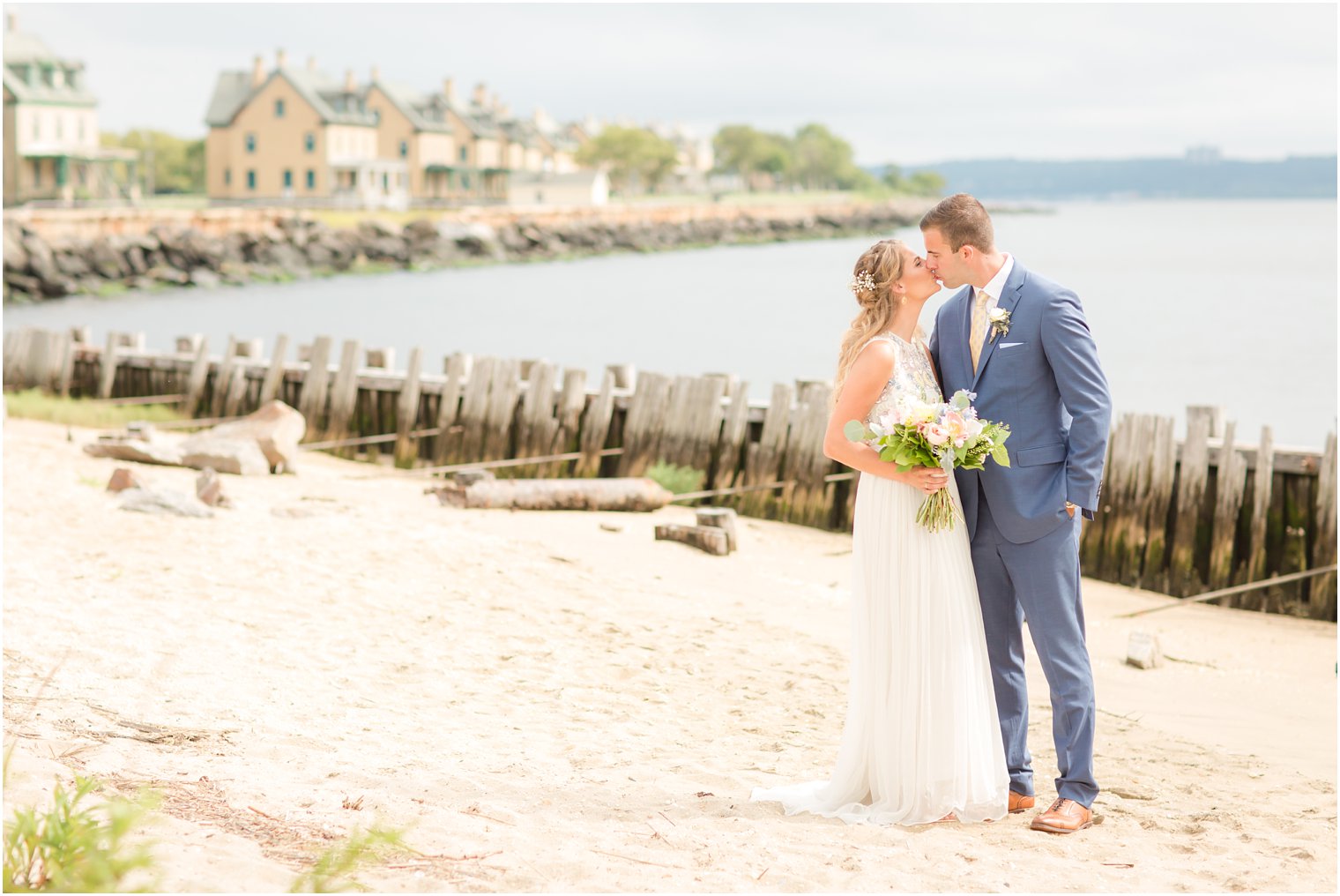 Bride and groom kissing in front of barracks