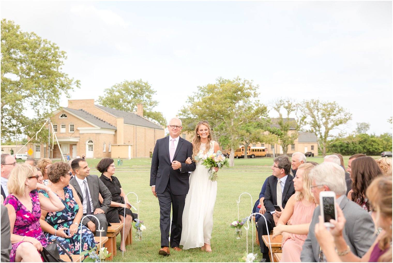 Bride and father walking during processional by NJ Wedding Photographers