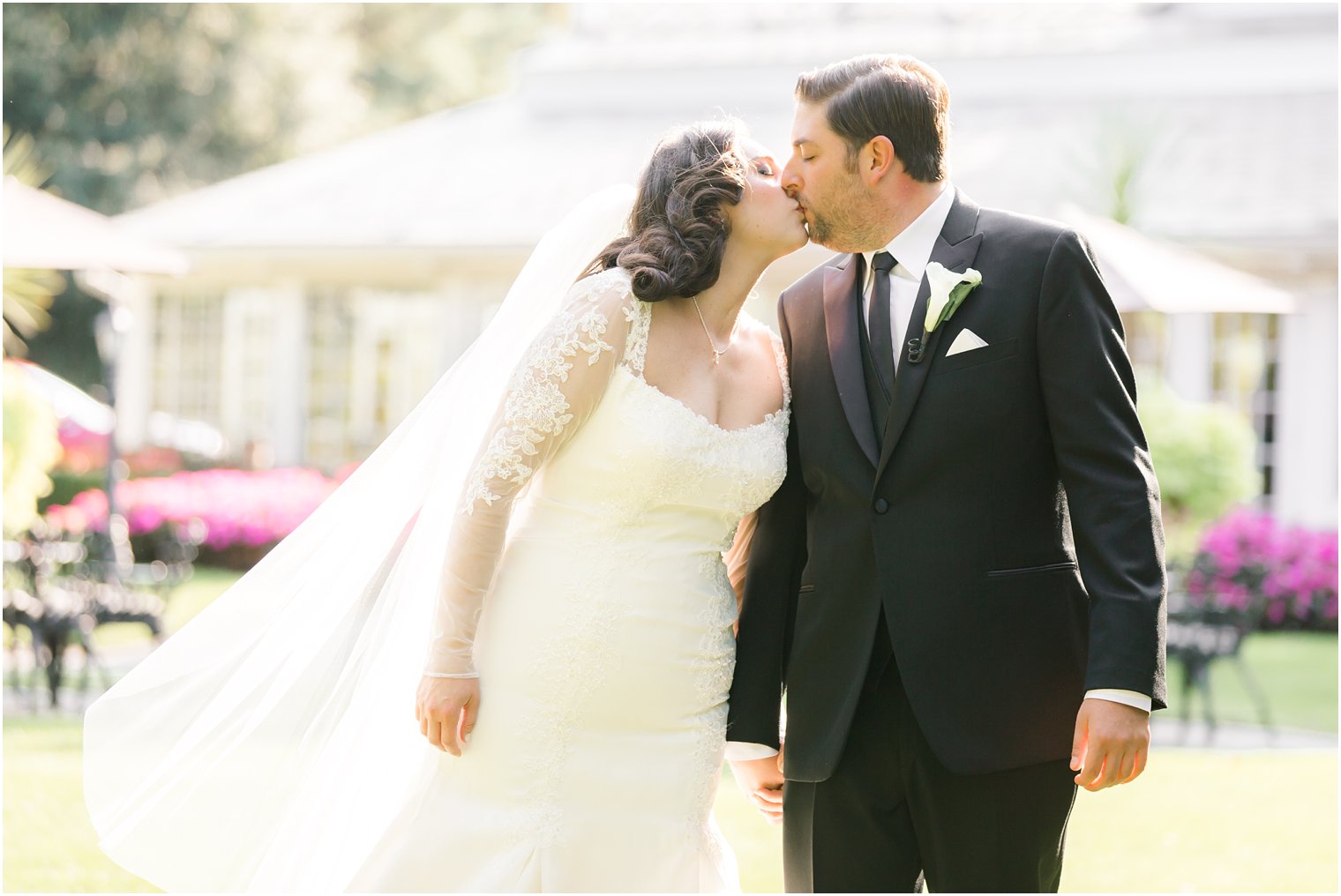 Bride and groom kissing by Shadowbrook Wedding Photographers Idalia Photography