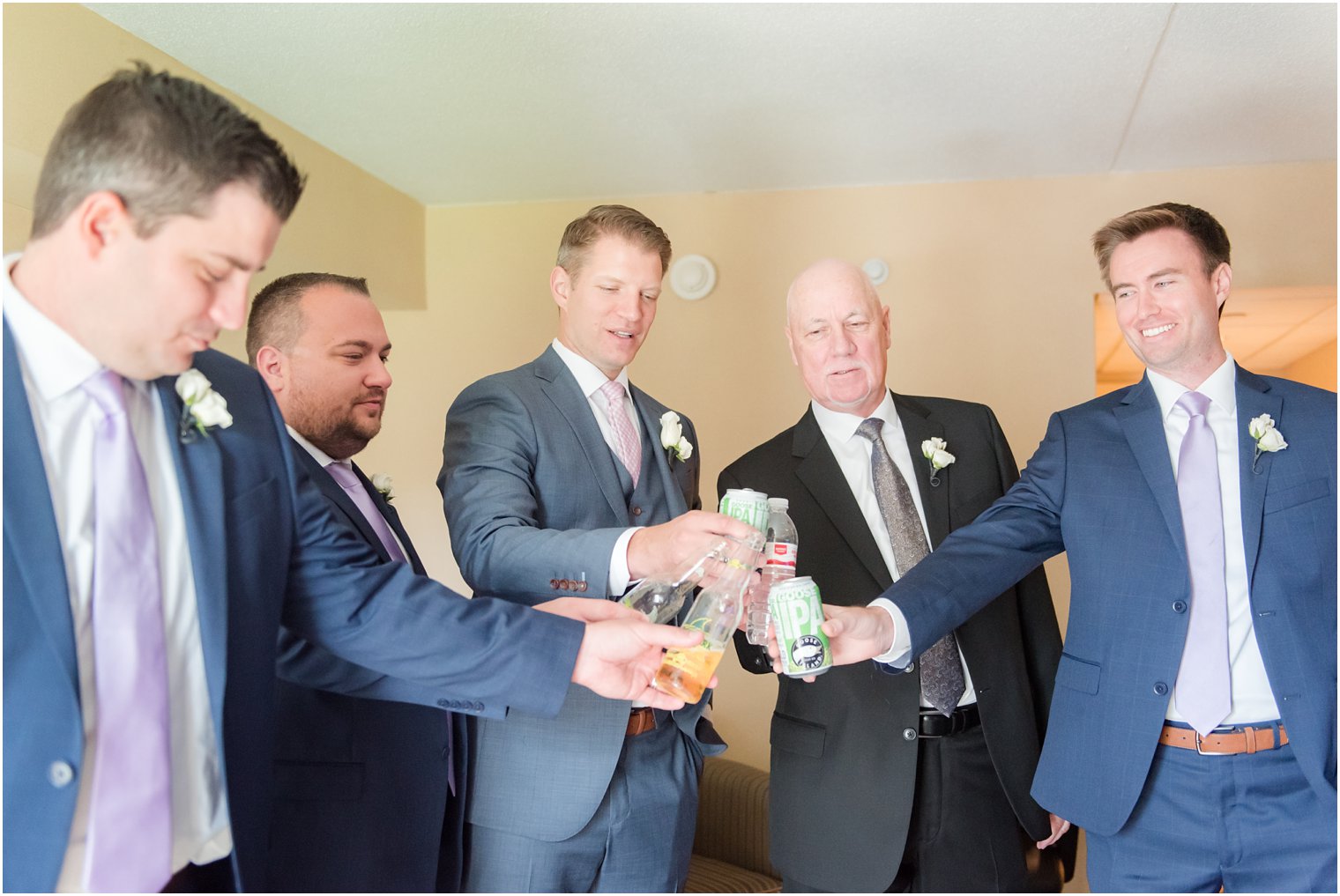 Groom toasting with groomsmen at Windows on the Water at Frogbridge Wedding