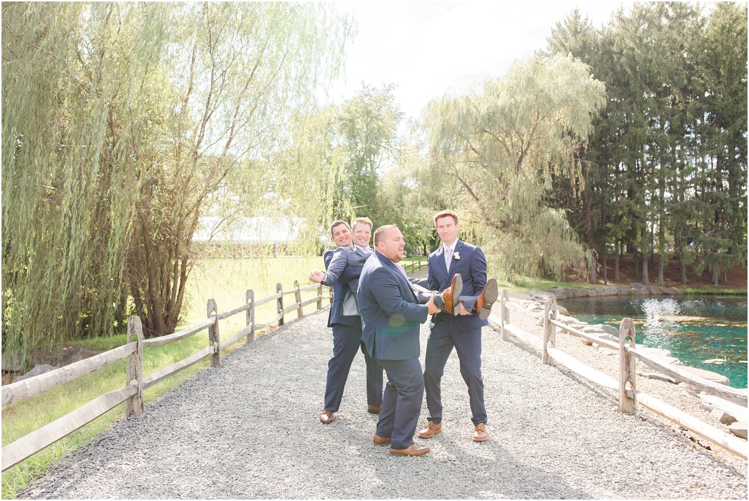 Candid groomsmen photo at Windows on the Water at Frogbridge Wedding