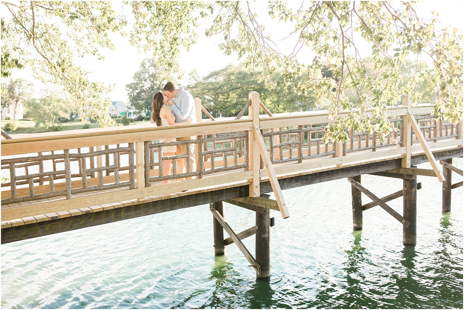 Engagement photo on bridge in Spring Lake