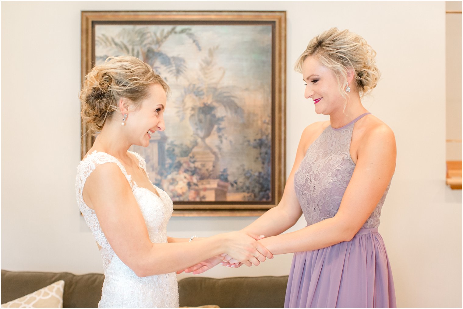 Bride and maid of honor getting ready on wedding day