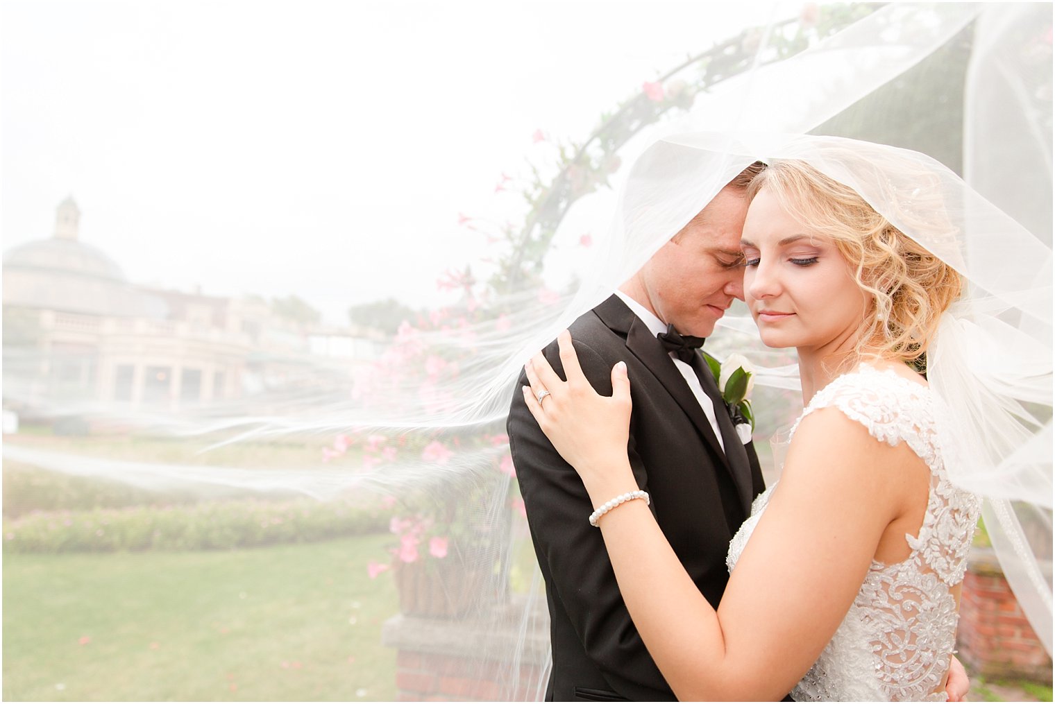 Romantic veil photo of bride and groom