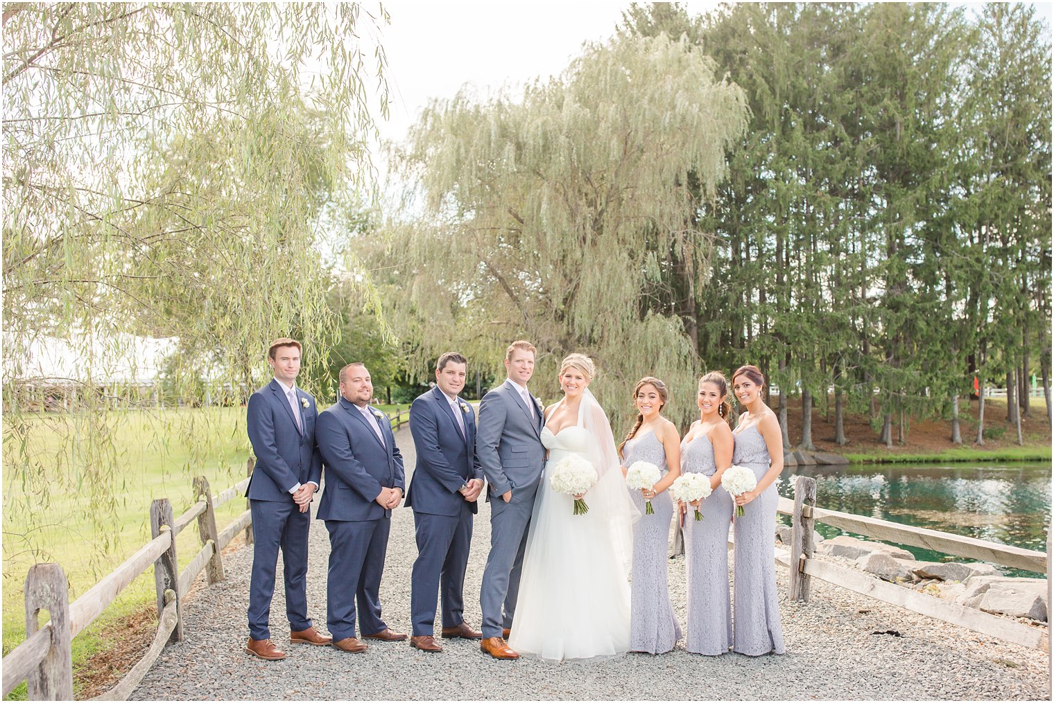 Bridal party photo by the willow trees at Windows on the Water at Frogbridge Wedding