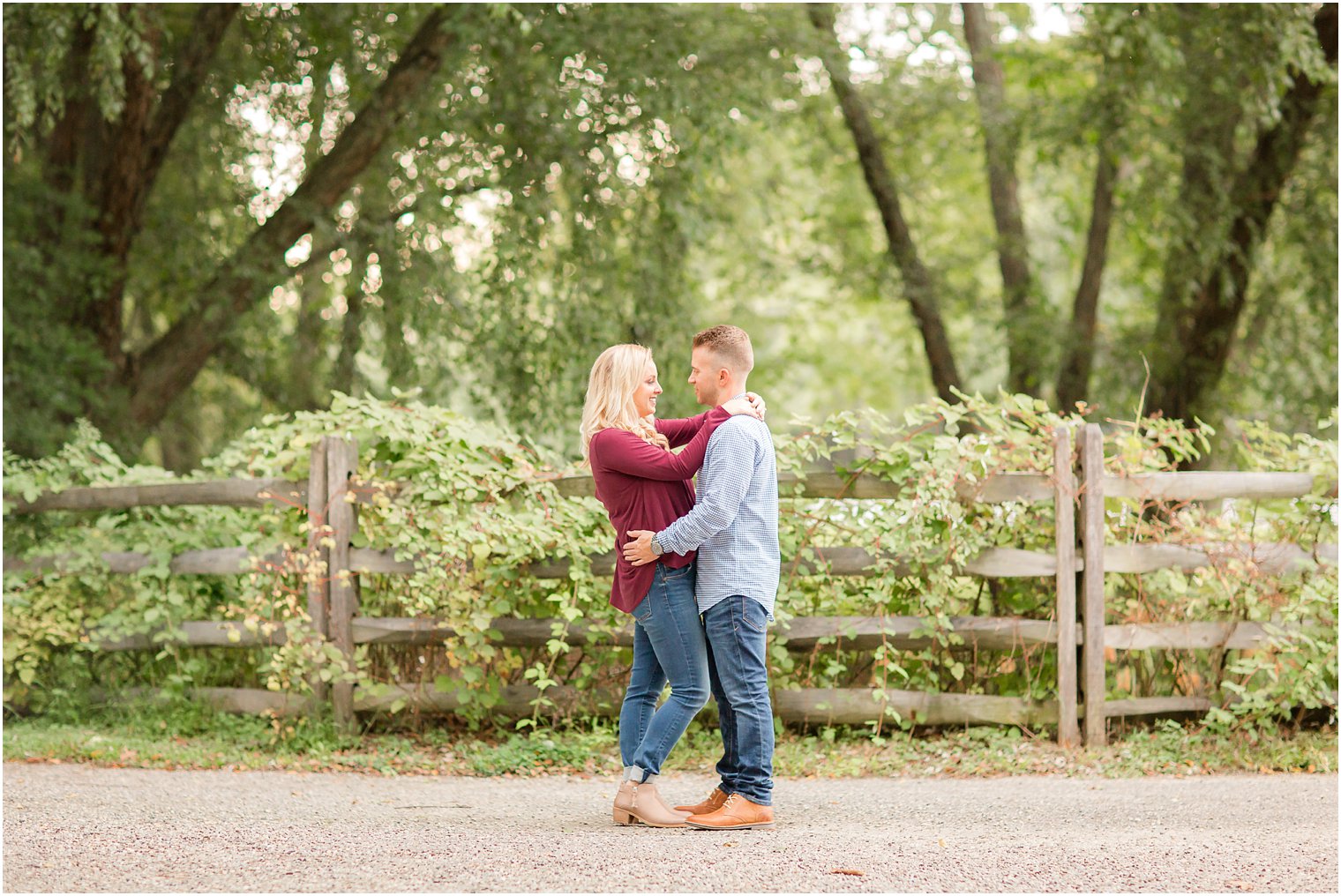 Engagement photo with ivy on wooden fence