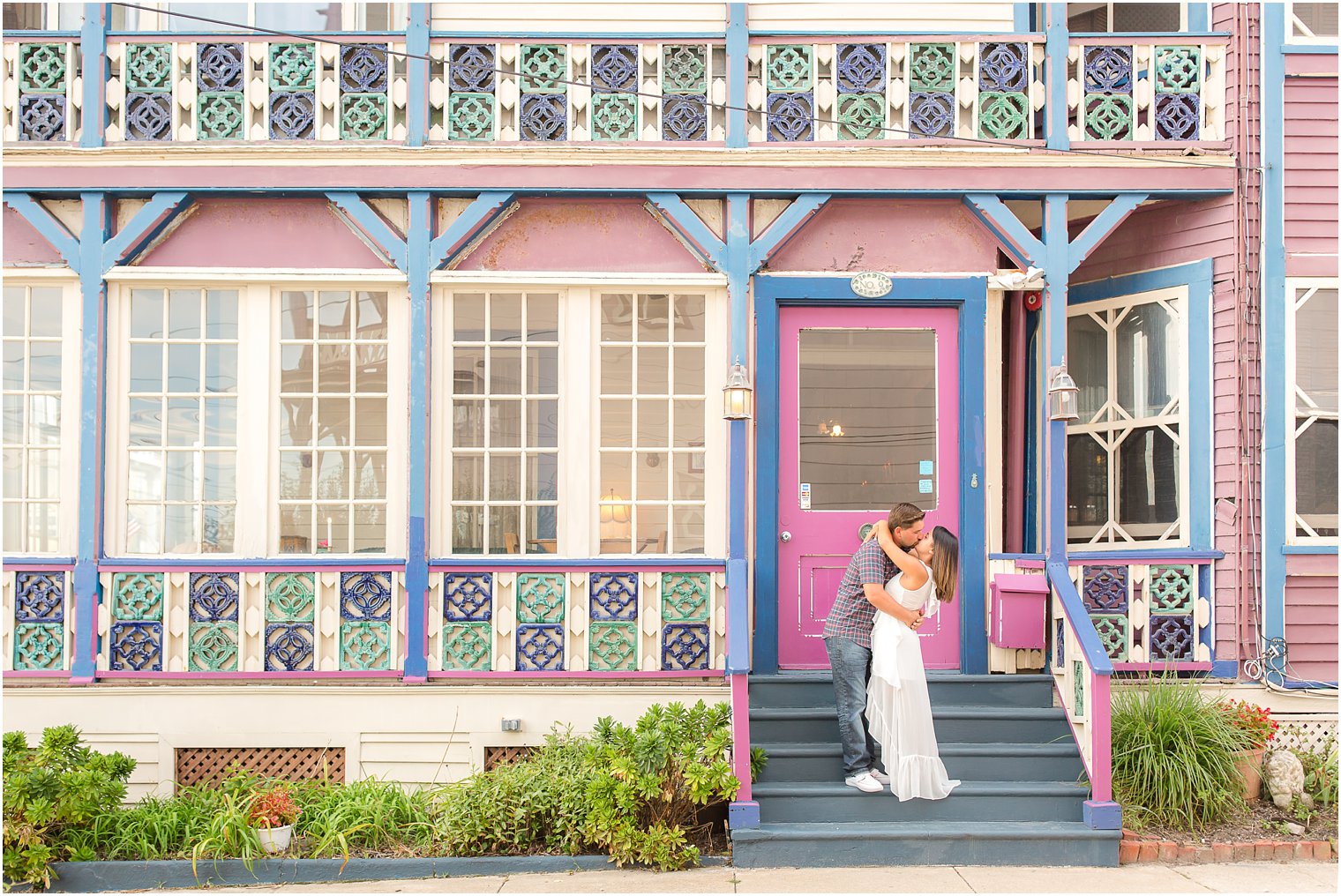 Engaged couple in front of old Victorian home