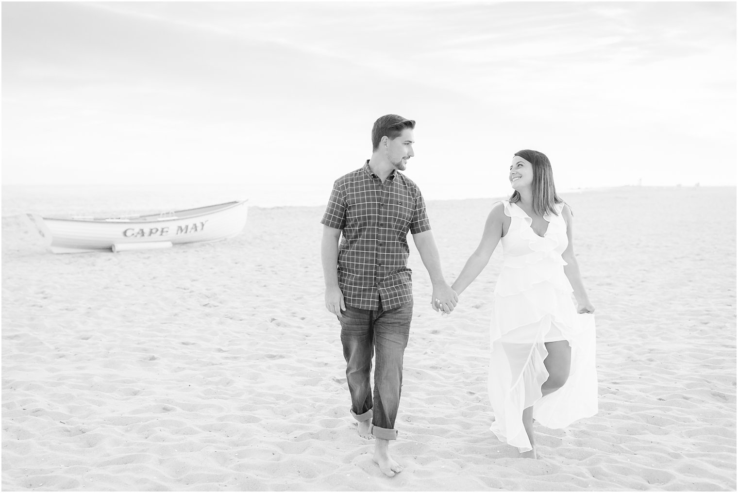 Candid black and white photo of couple walking