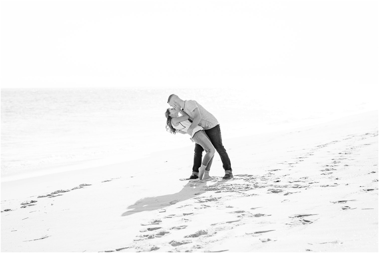 Groom dips bride at Cape May Engagement | Photos by Idalia Photography