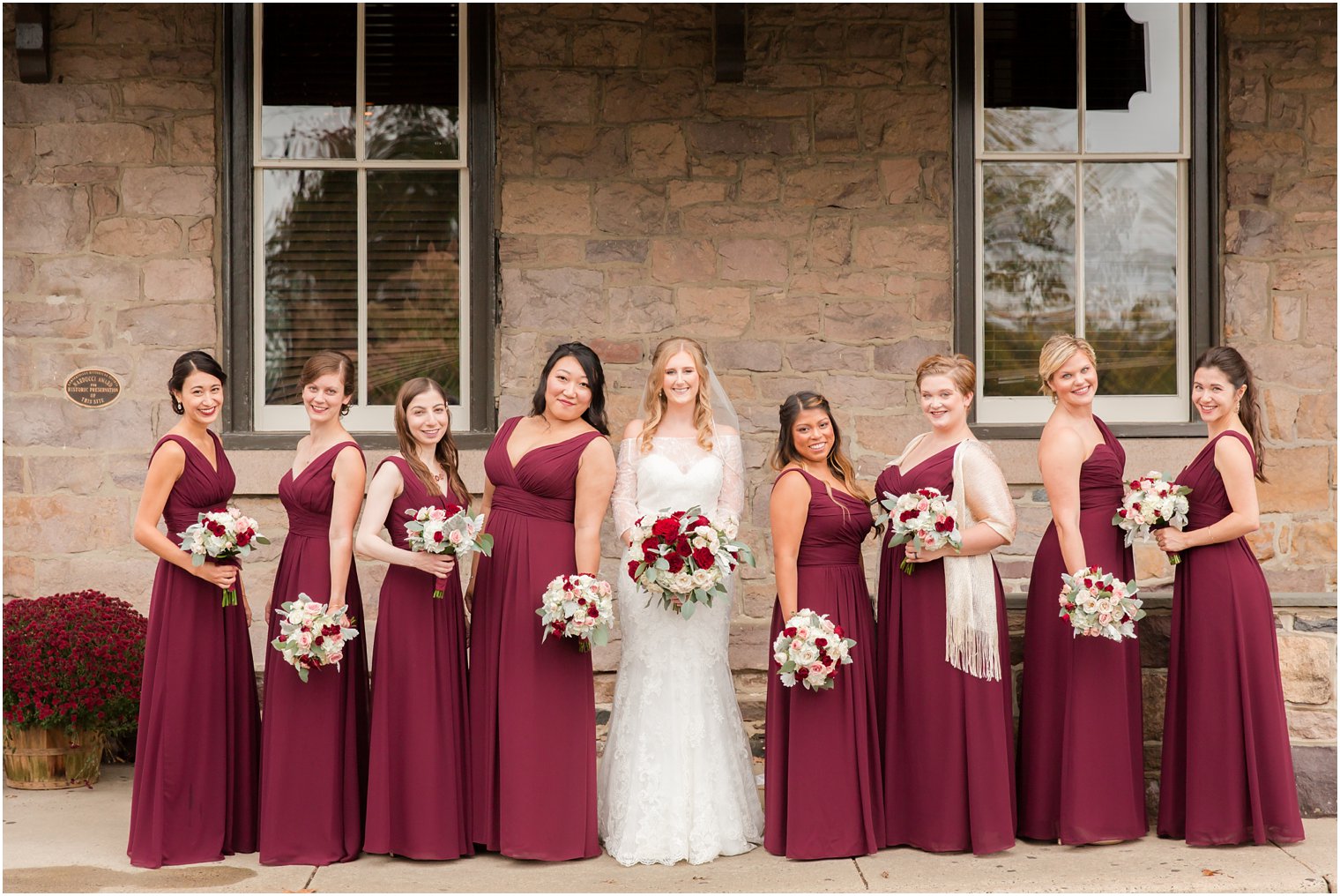 Bridesmaids wearing burgundy Bill Levkoff dresses