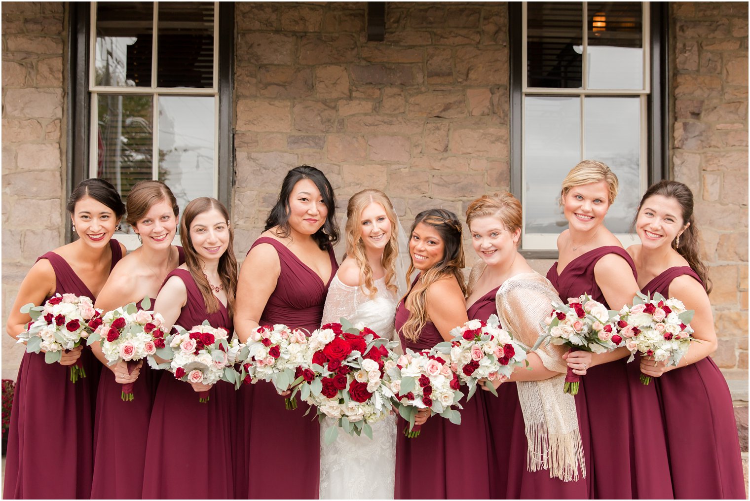 Bridesmaids wearing marsala Bill Levkoff dresses