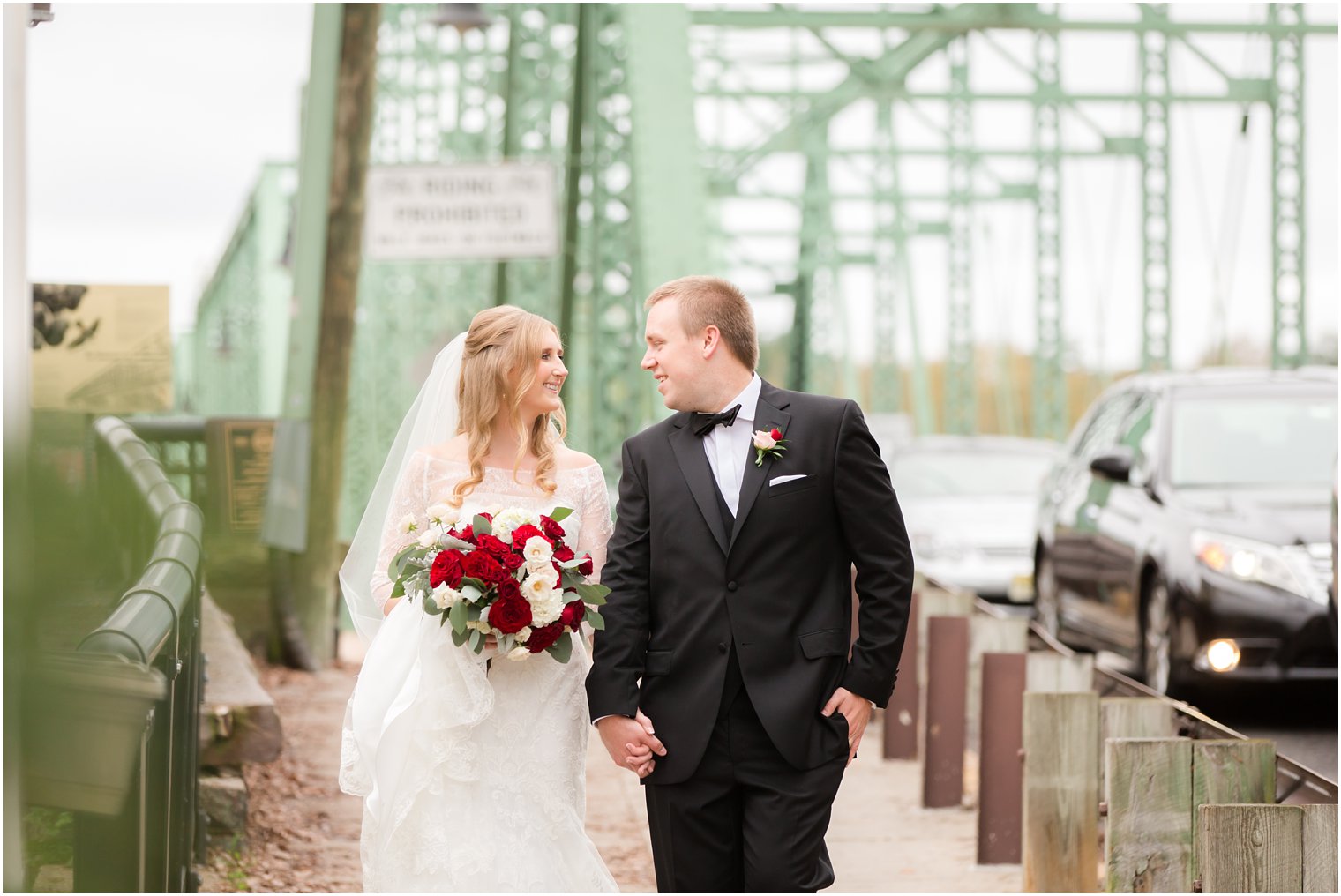 Bride and groom walking off the bridge