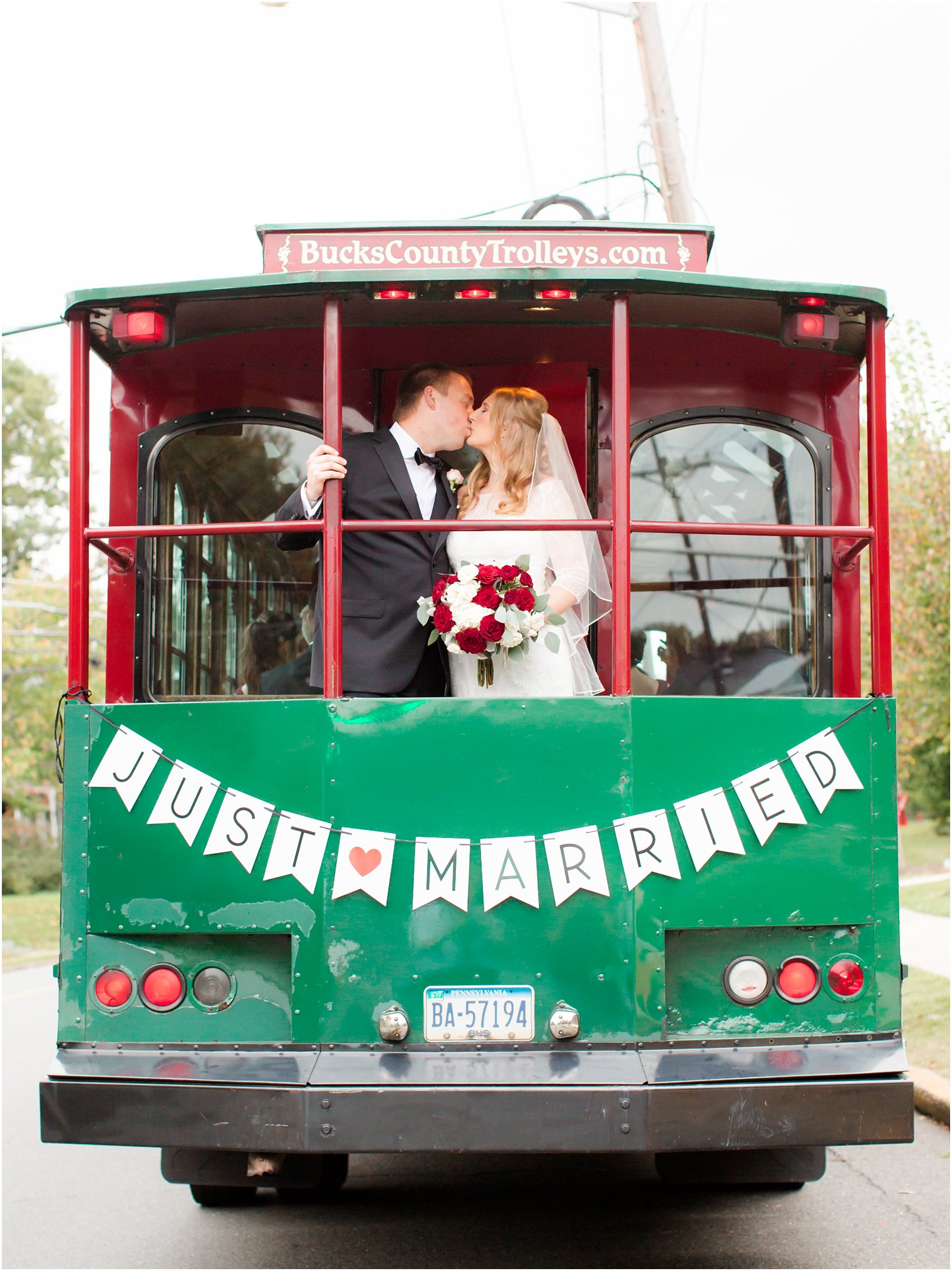 Bride and groom in Bucks County Trolley with "Just Married" sign