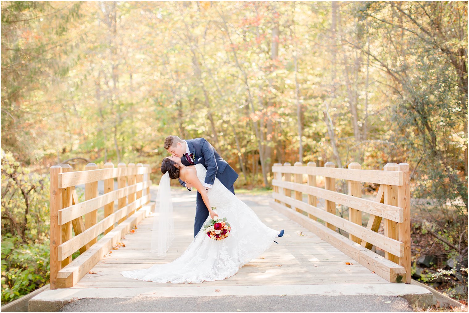Groom dipping his bride on a park bridge | Photos by NJ Wedding Photographers Idalia Photography