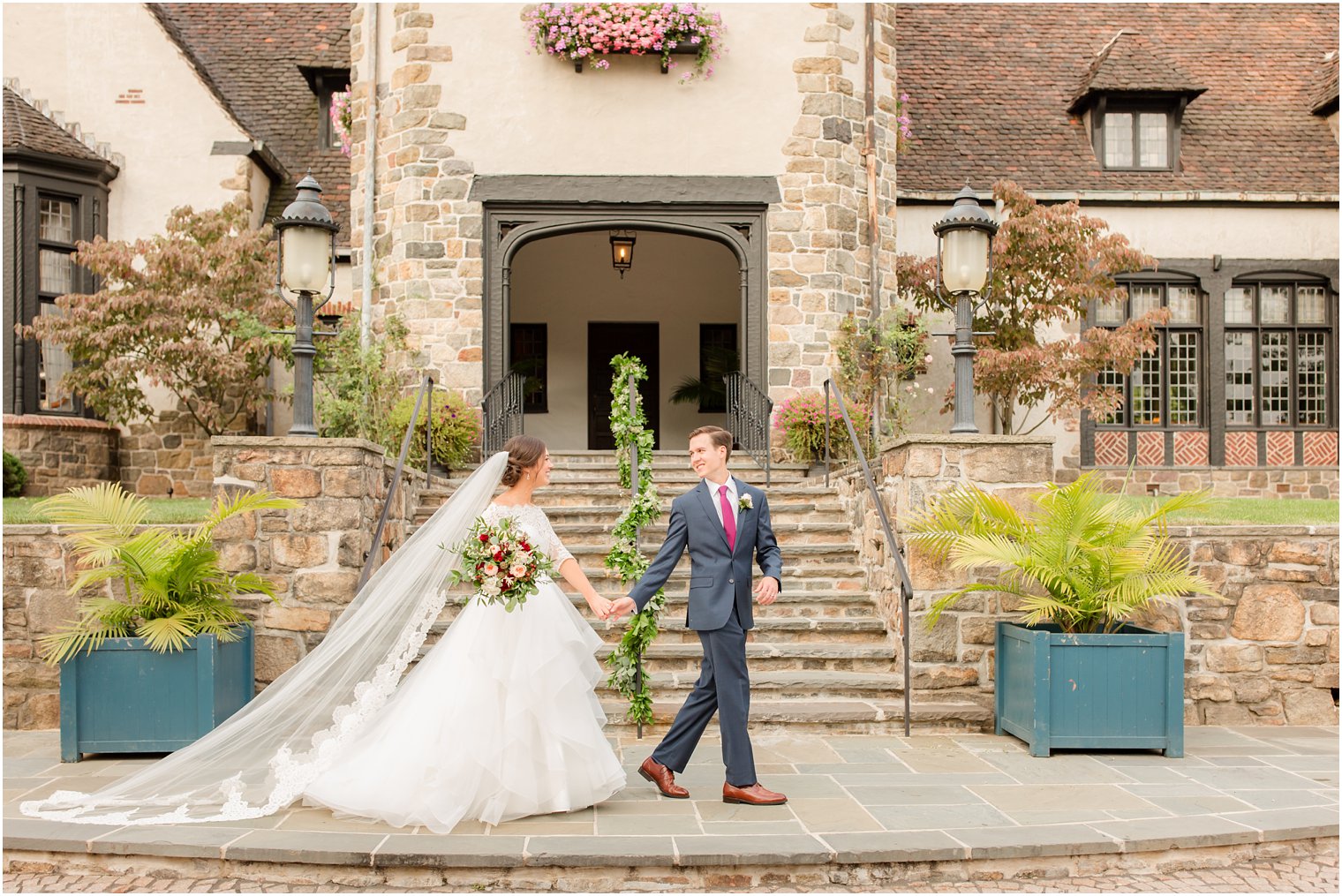 Bride and groom walking on the grounds of Pleasantdale Chateau in West Orange, NJ