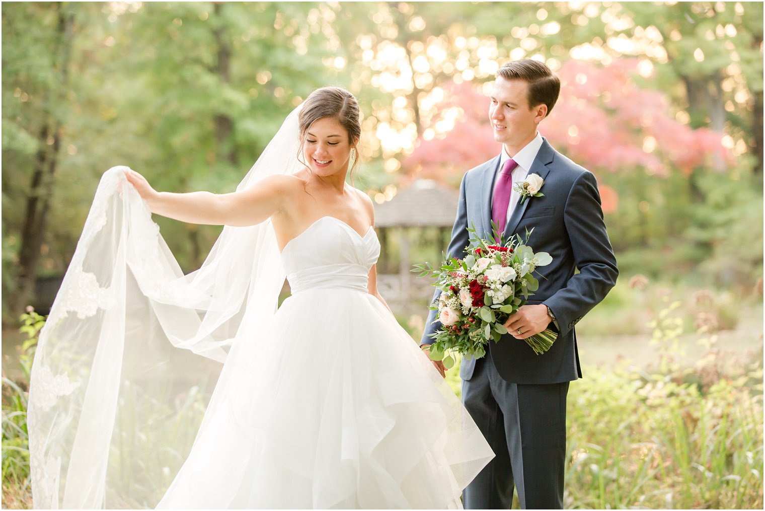 Bride and cathedral veil photo with groom in navy suit