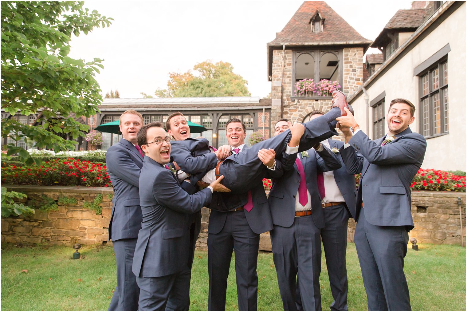 Fun and candid photo of groom and groomsman on wedding day