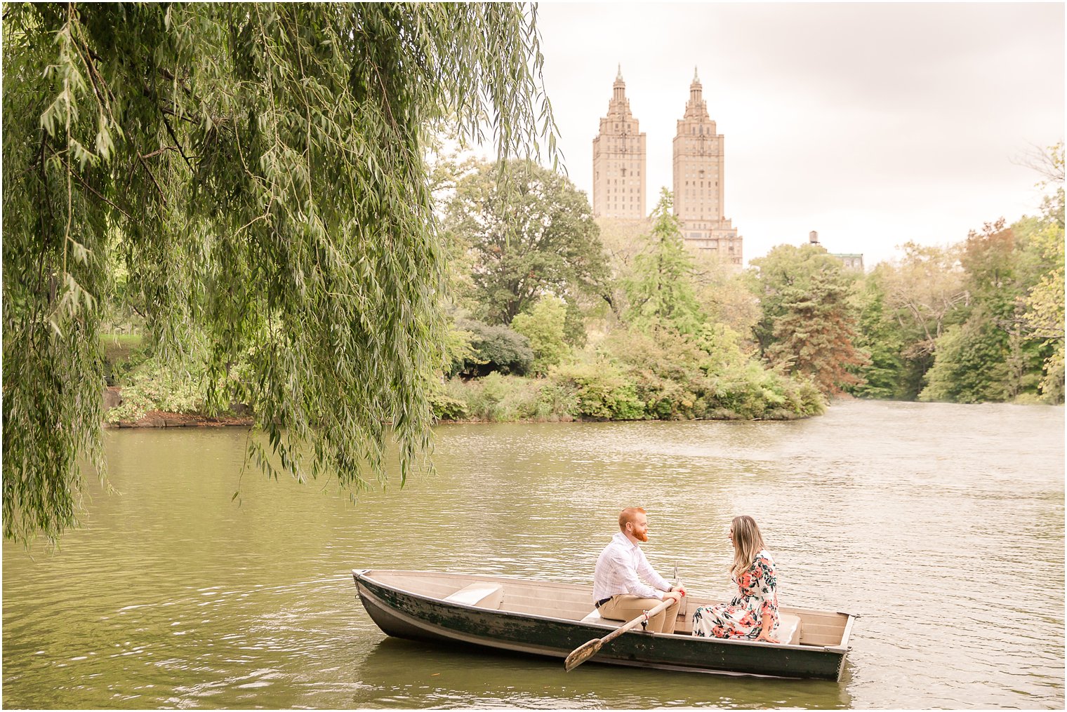 Couple on a boat under a willow tree in Central Park