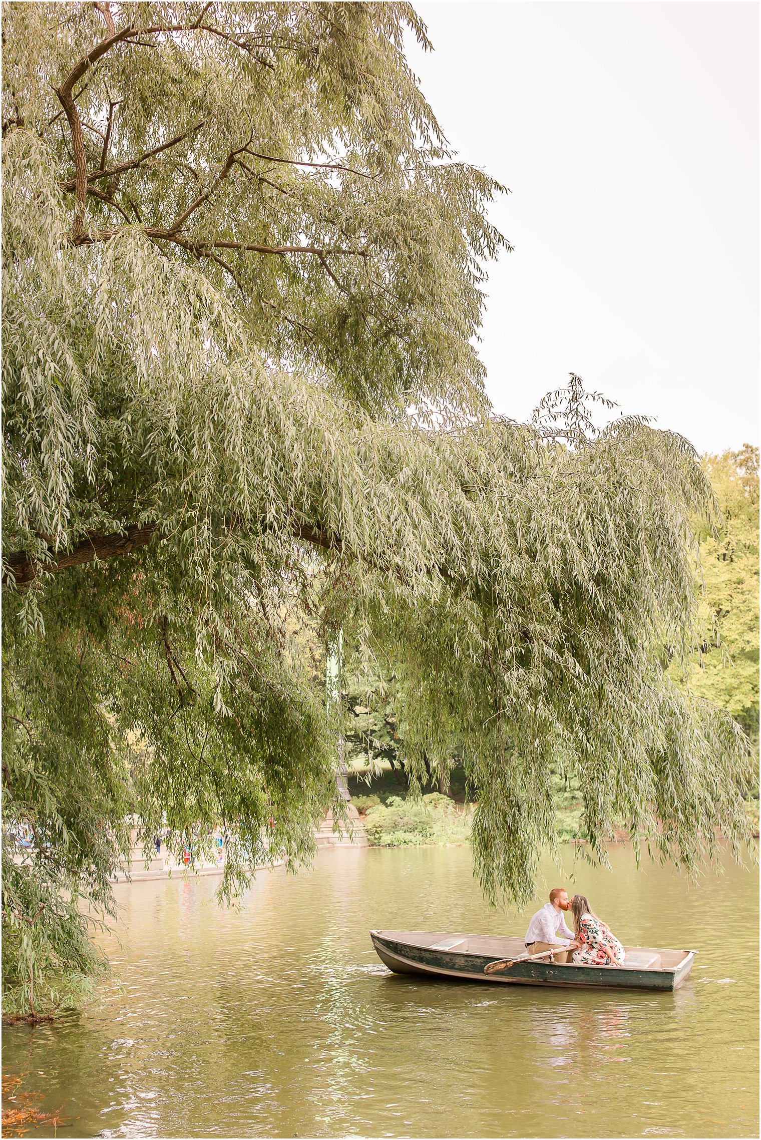 Romantic engagement photo in Central Park under a weeping willow tree