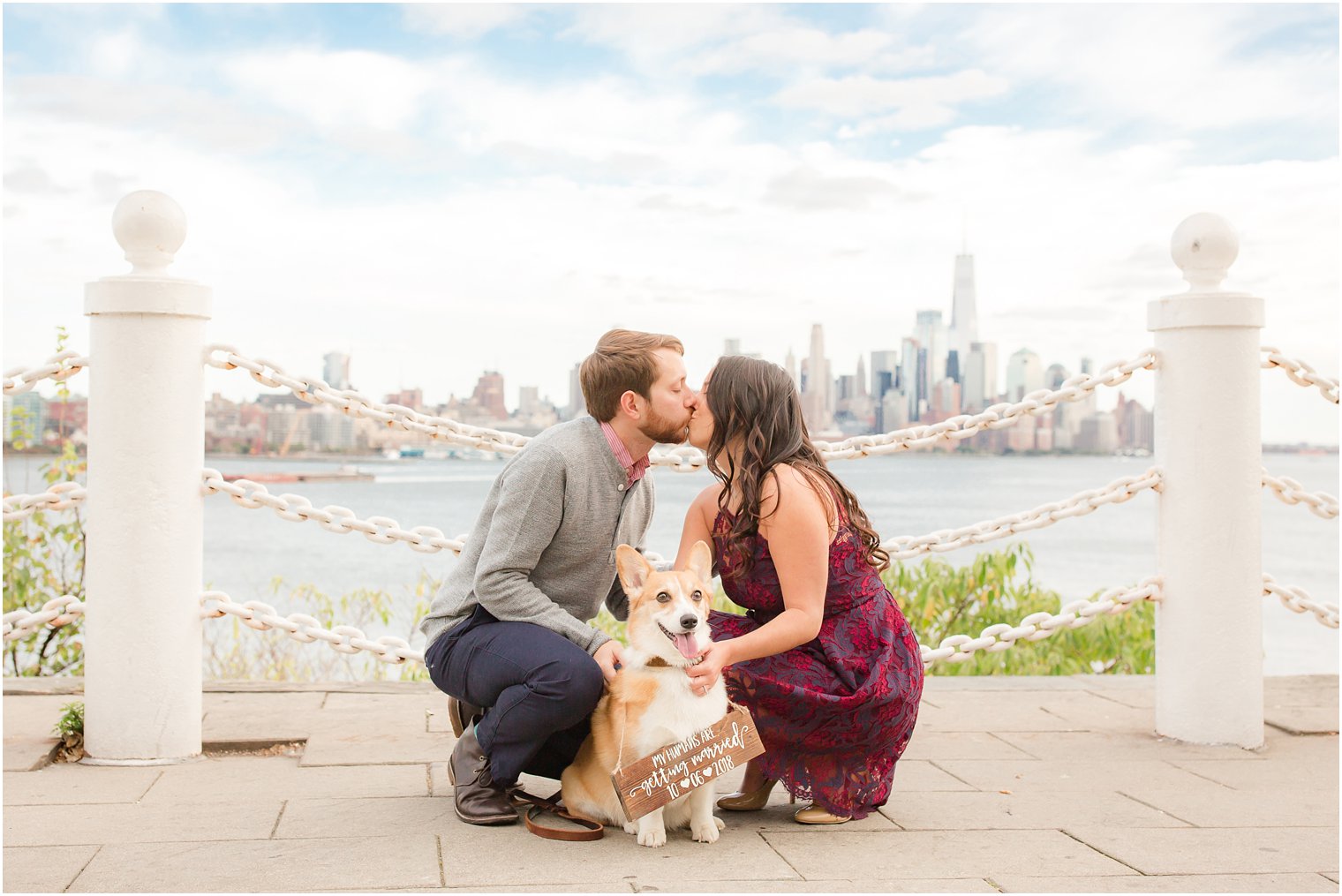 Engagement photo with dog and wooden sign