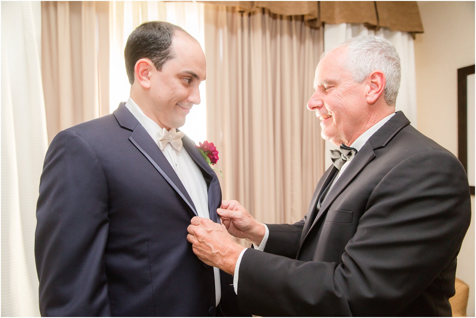 Groom getting ready with father