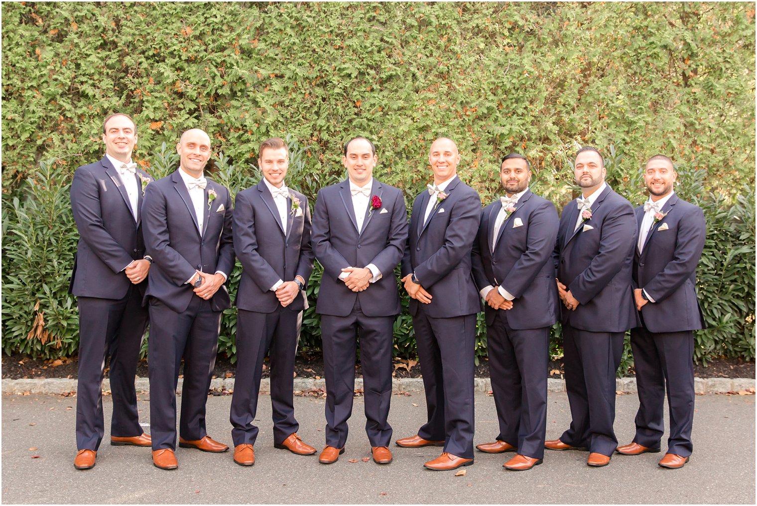 Groomsmen in navy suits and brown shoes