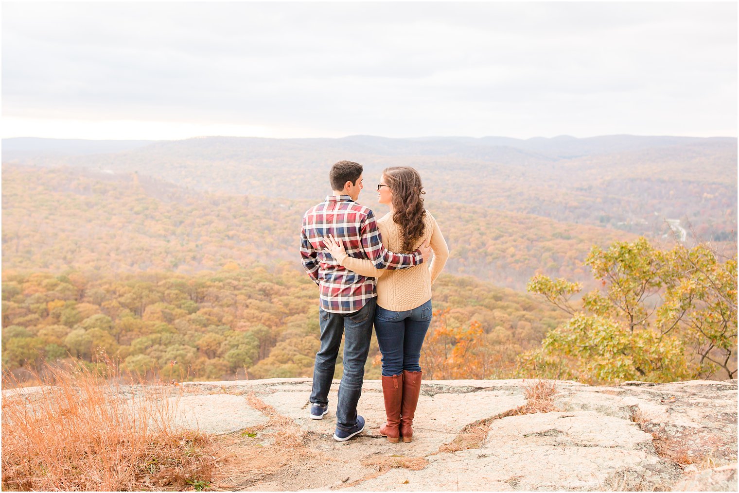 Couple posing for photos on a mountaintop