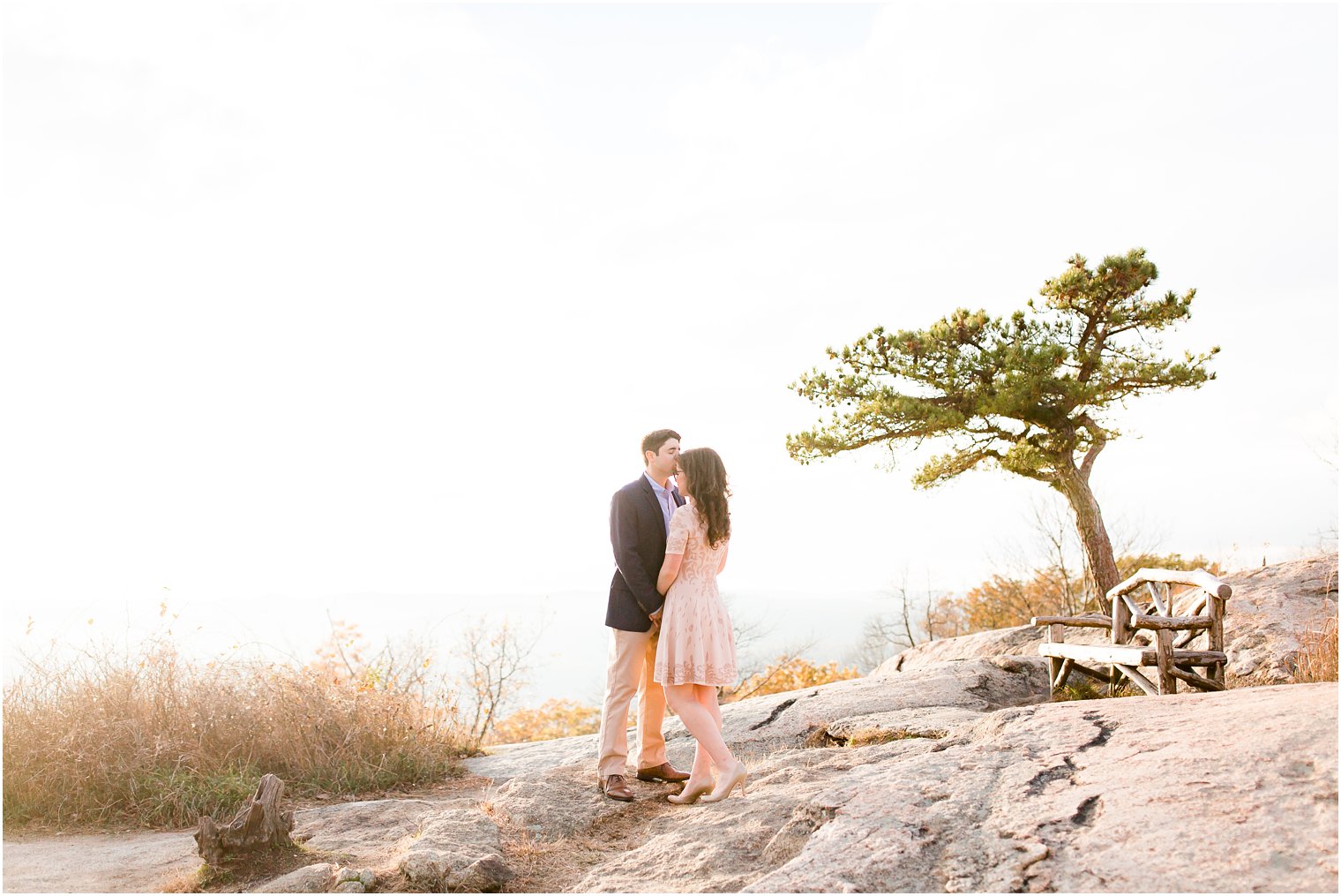 Romantic photo of bride and groom on a mountaintop