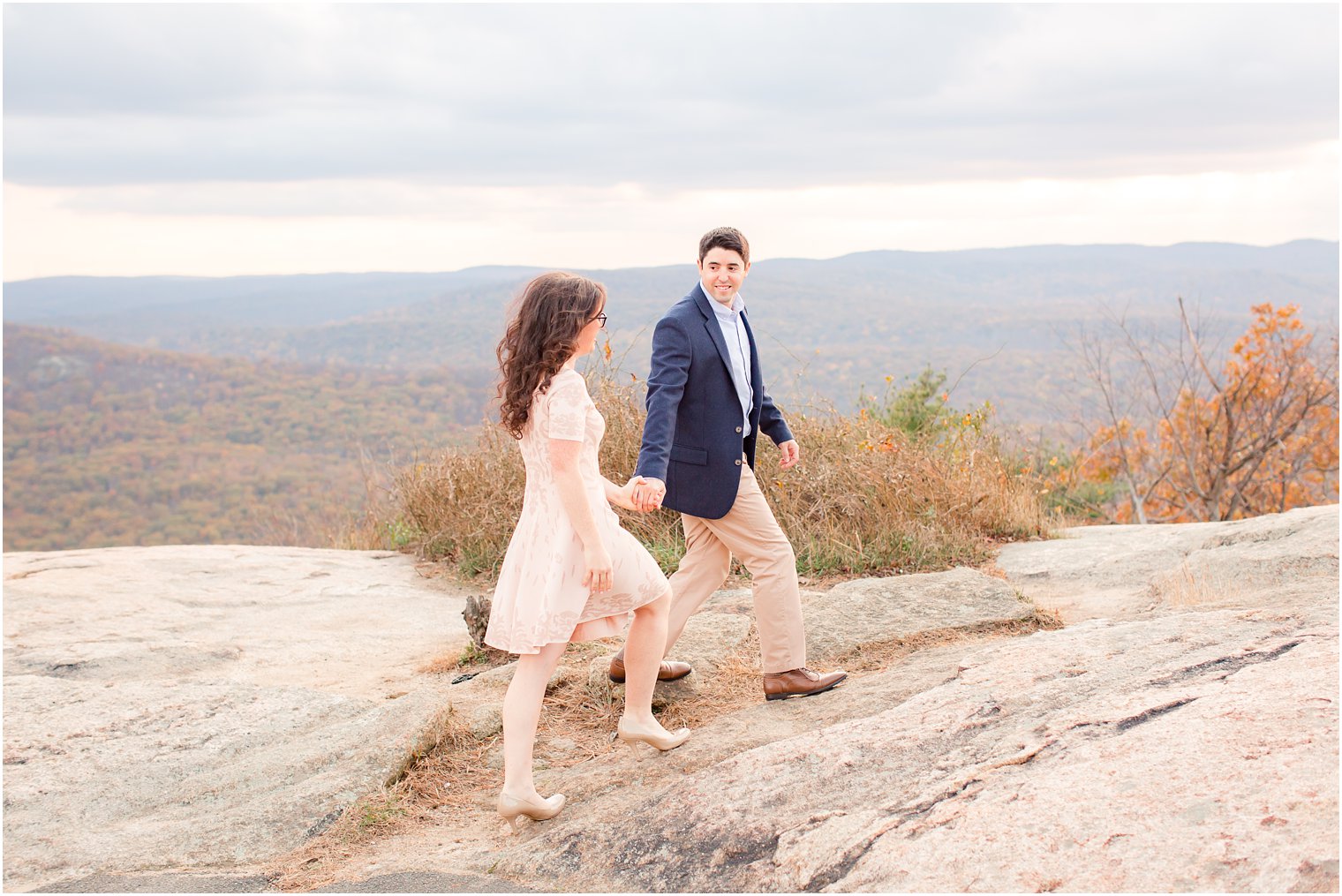 Groom leading bride for engagement photos