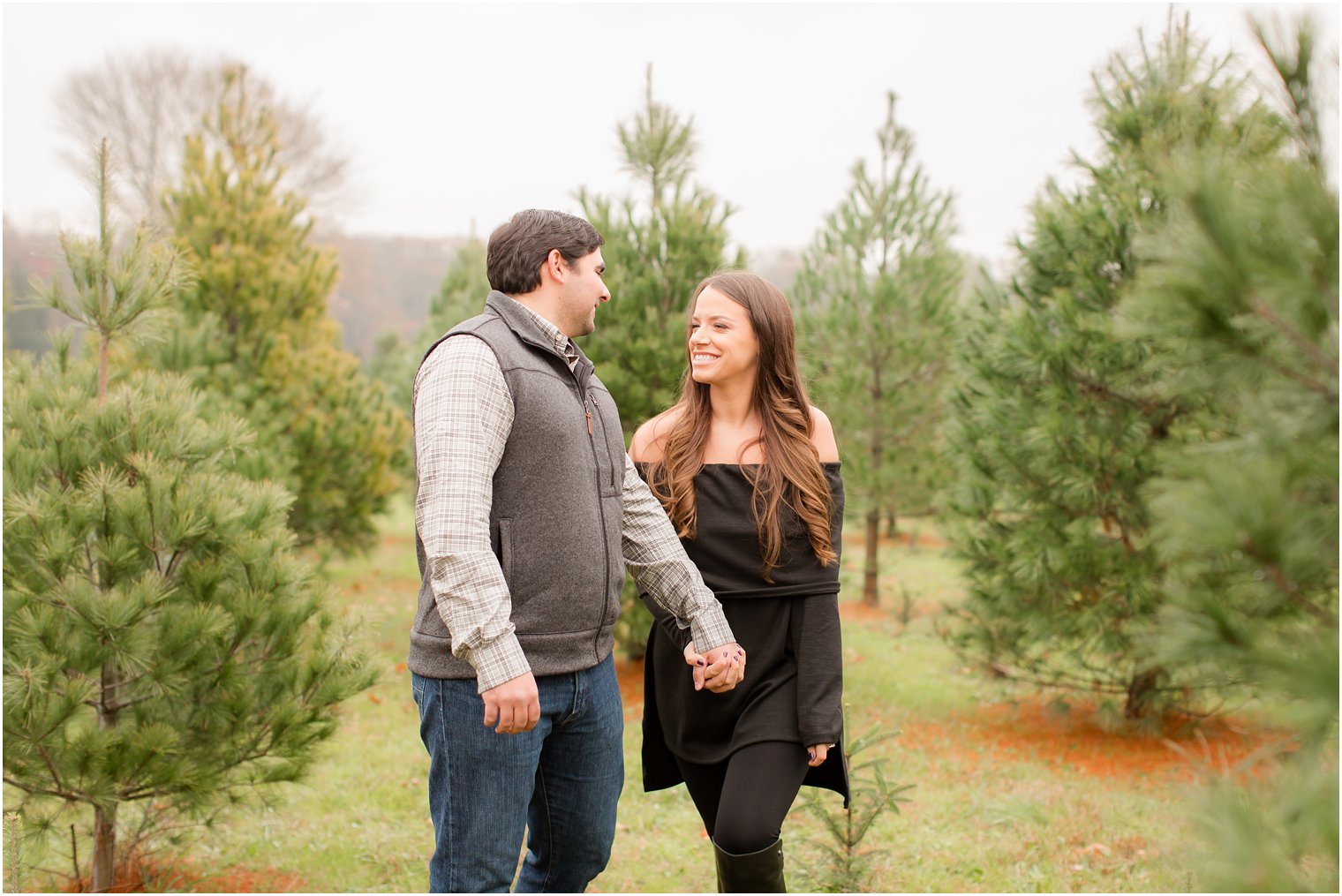 Engagement photo posing ideas for a Christmas tree farm engagement session
