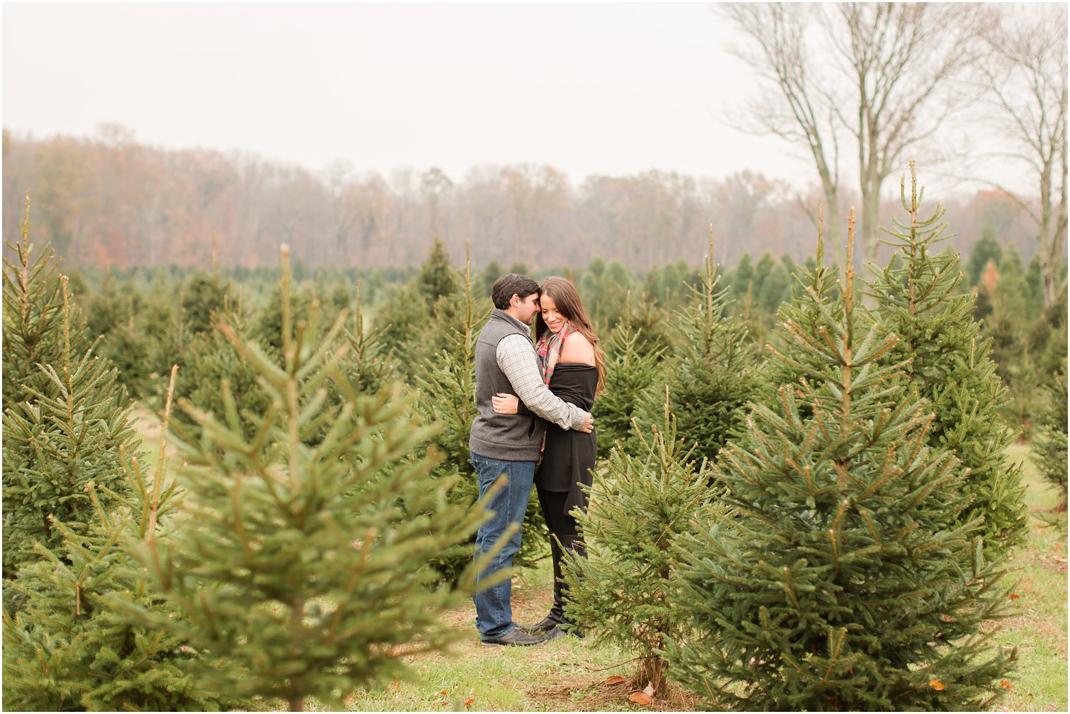 Engaged couple posing in large field