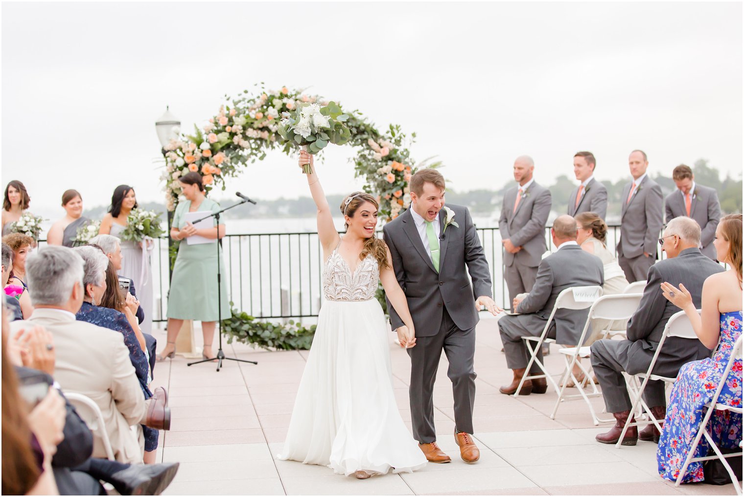 Excited bride and groom at wedding ceremony recessional 