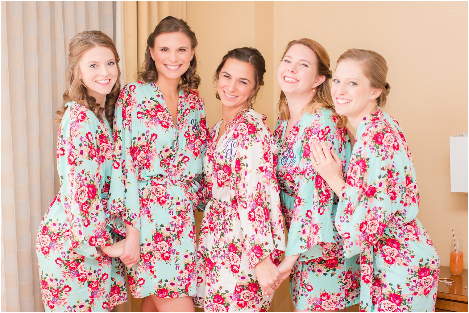 Bridesmaids in mismatched floral robes