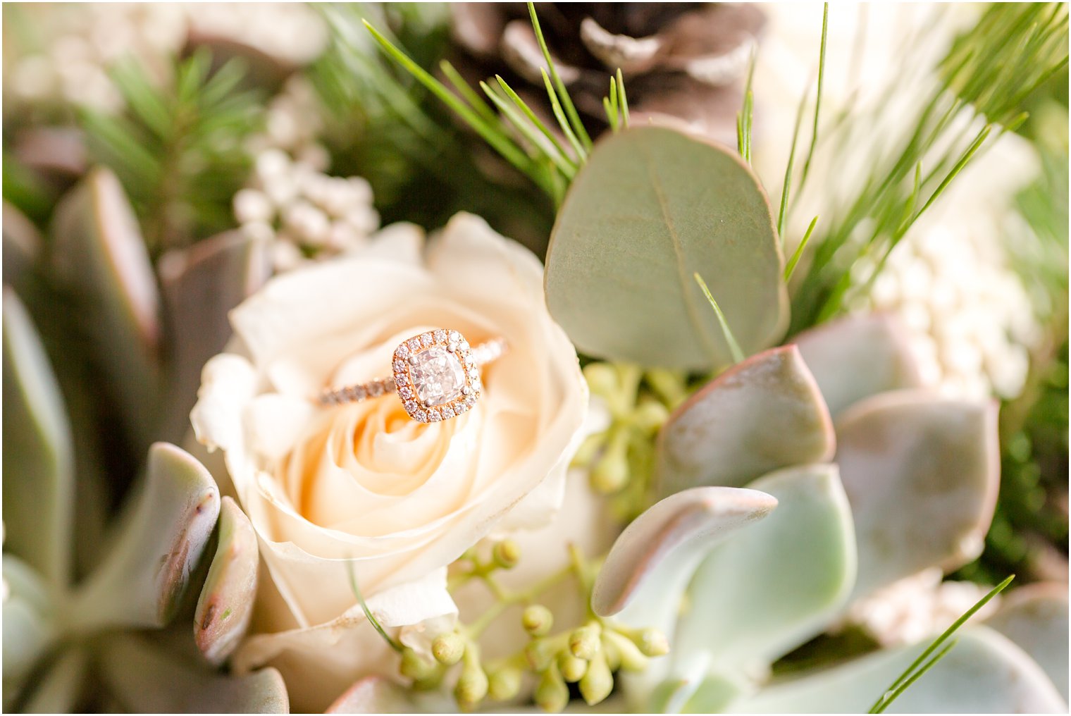 Engagement ring in bouquet with winter greenery