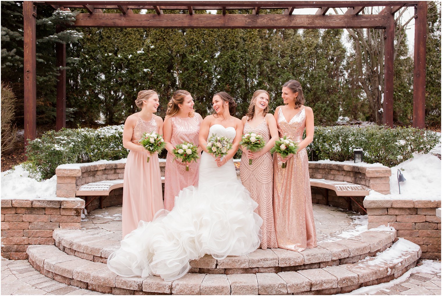Bridesmaids wearing rose gold dresses at winter wedding | Stone House at Stirling Ridge in Warren, NJ