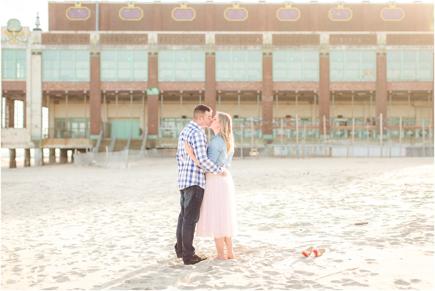 Bride and groom kissing in front of convention hall