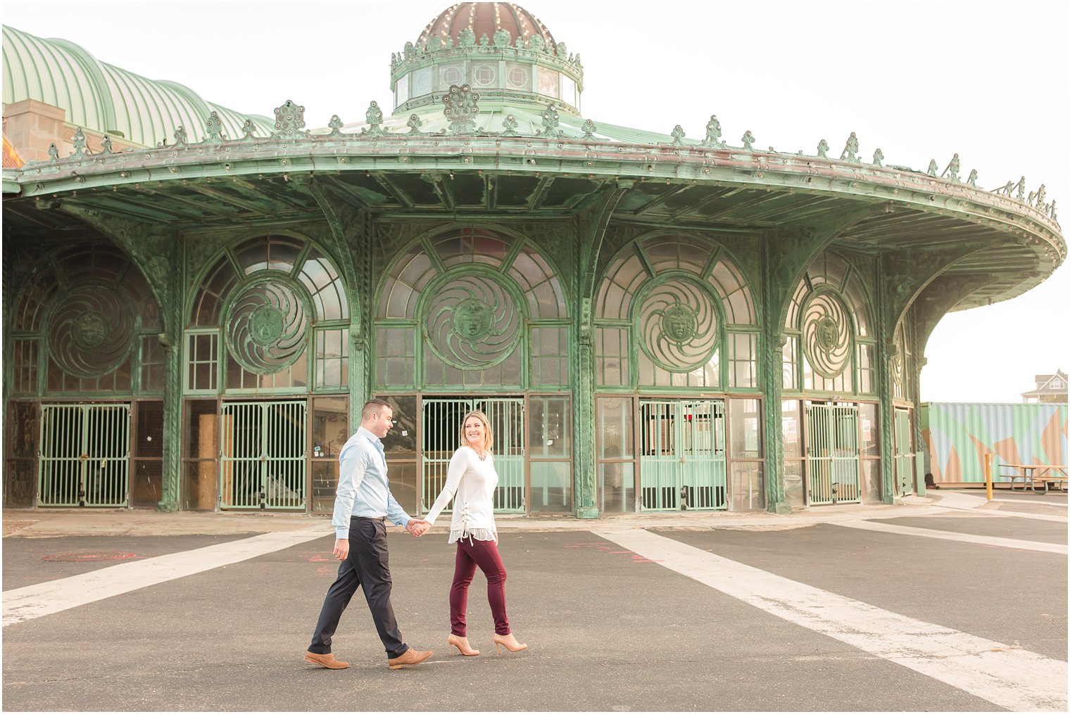 Bride walking with groom near Asbury Park Old Casino