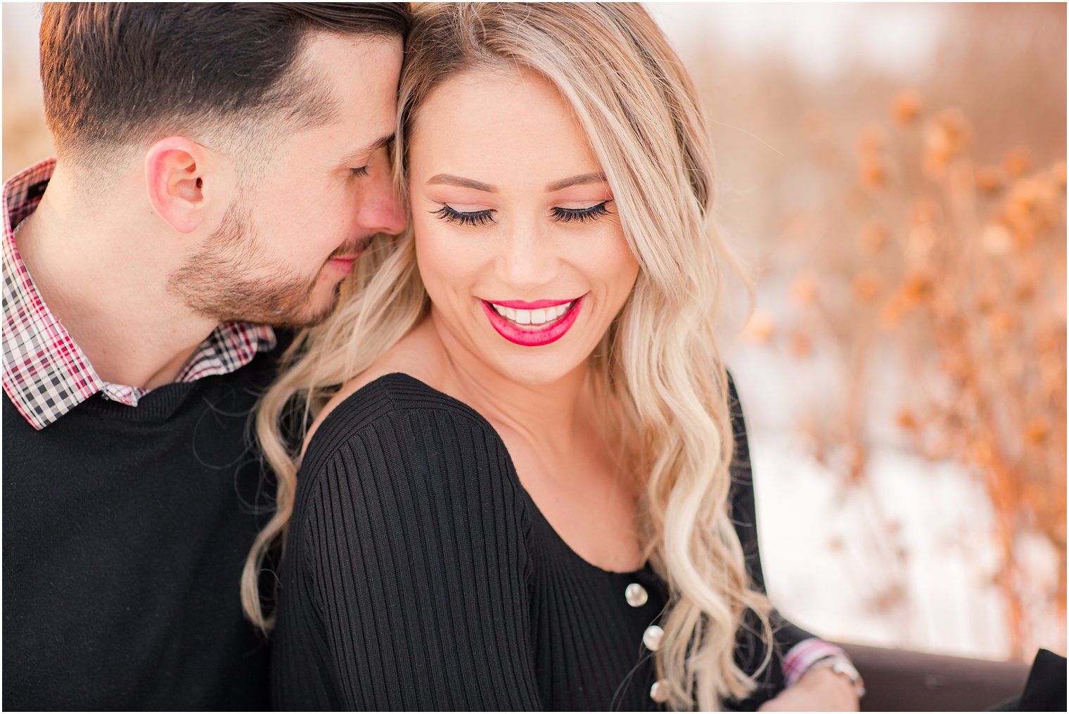 Romantic photo of bride and groom during snowy engagement