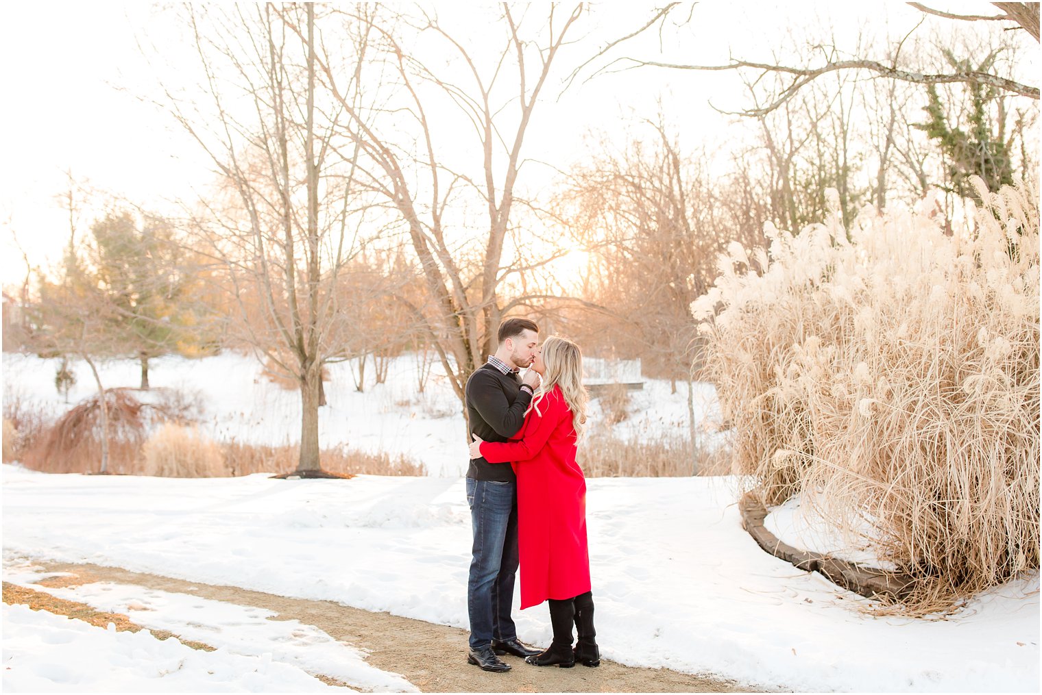 Sunset portrait of engaged couple in the snow