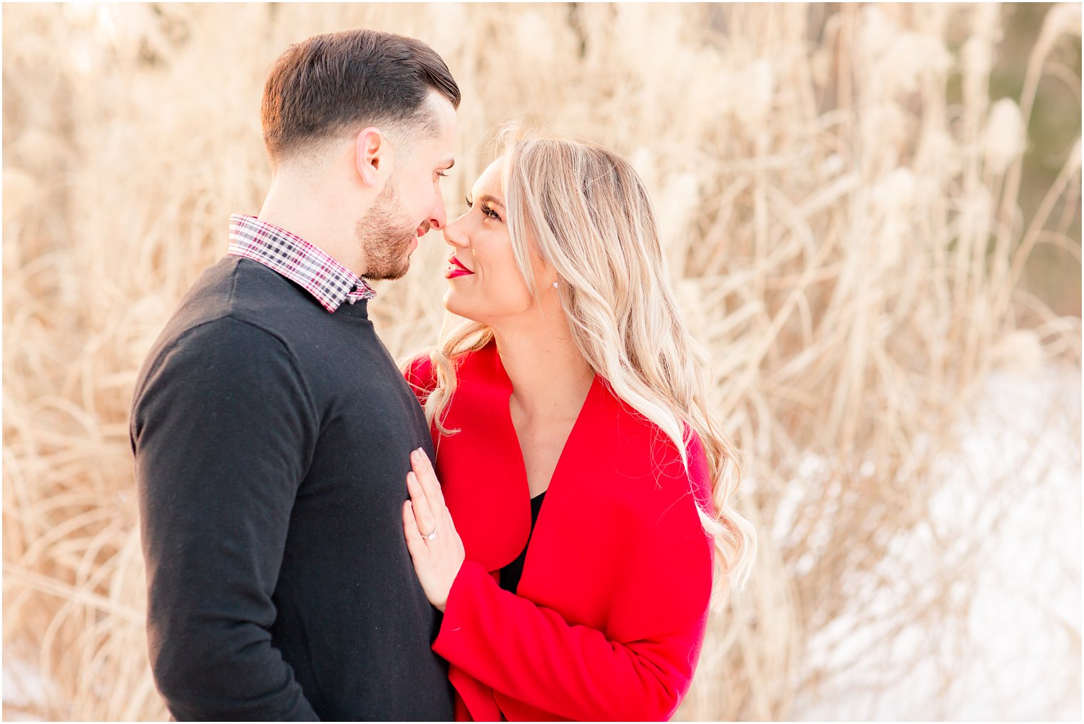 Romantic engagement photo with tall grasses