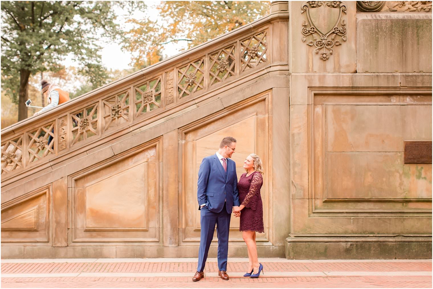 groom wearing blue suit and bride wearing burgundy dress