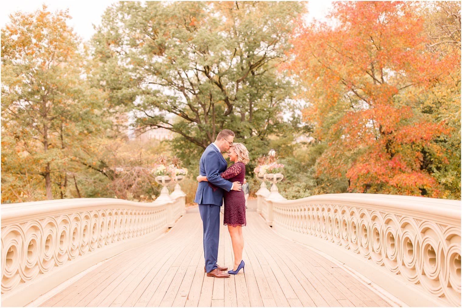 photo of couple on bow bridge in central park