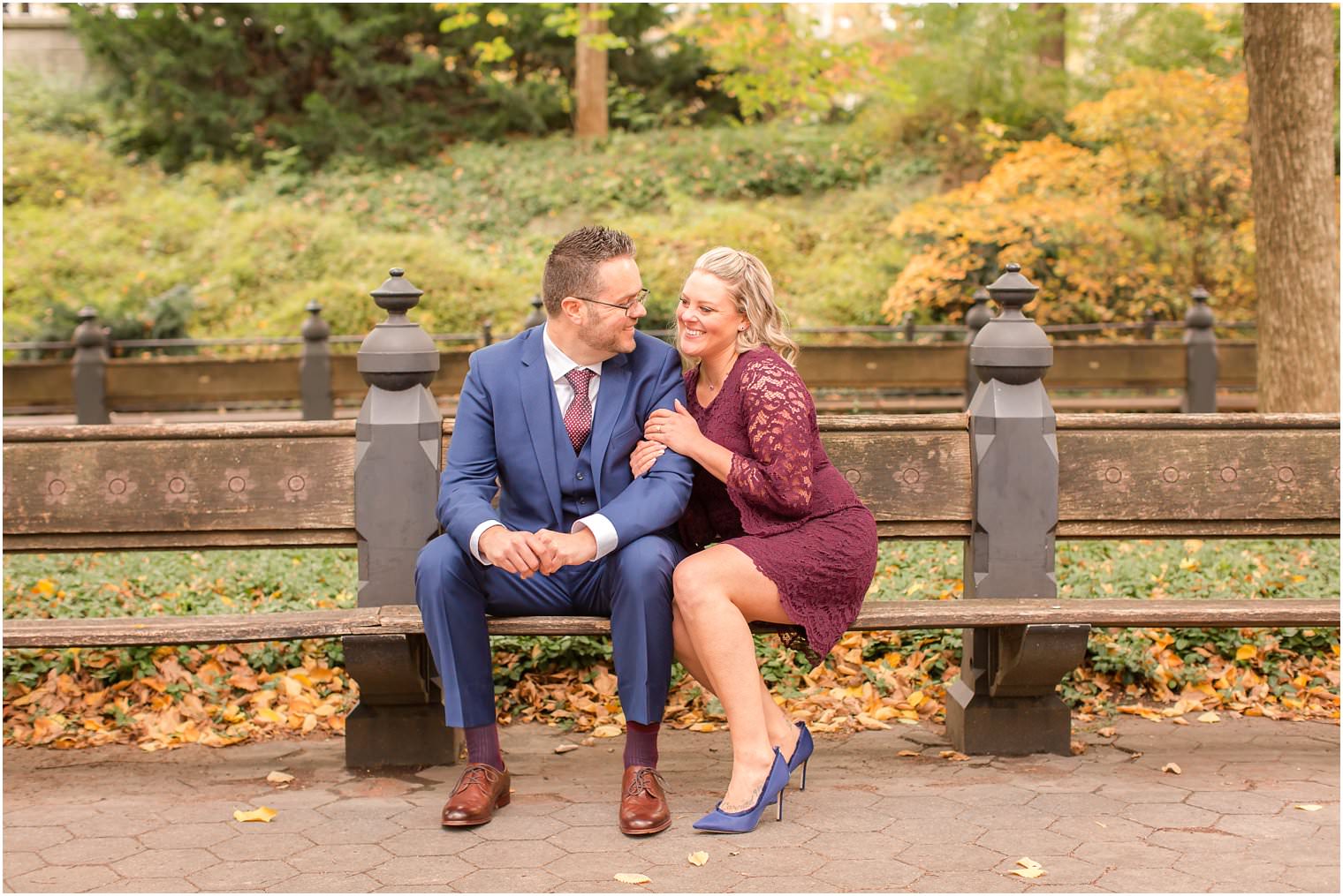 photo of bride and groom sitting on a bench in central park